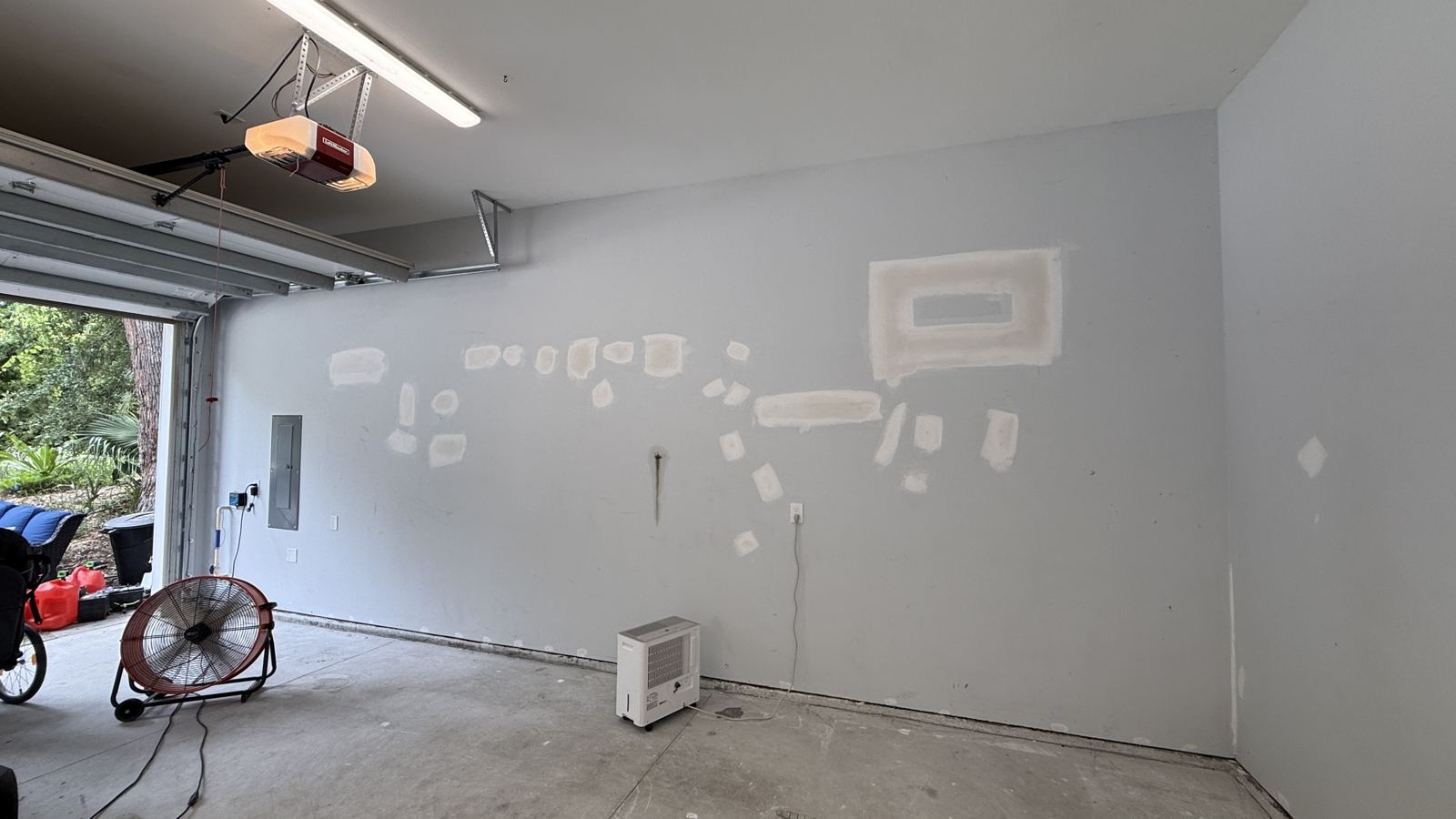 Bare stained concrete garage floor before coating