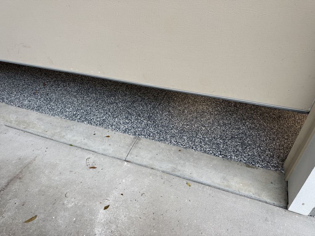 Finished coating detail at a garage threshold edge