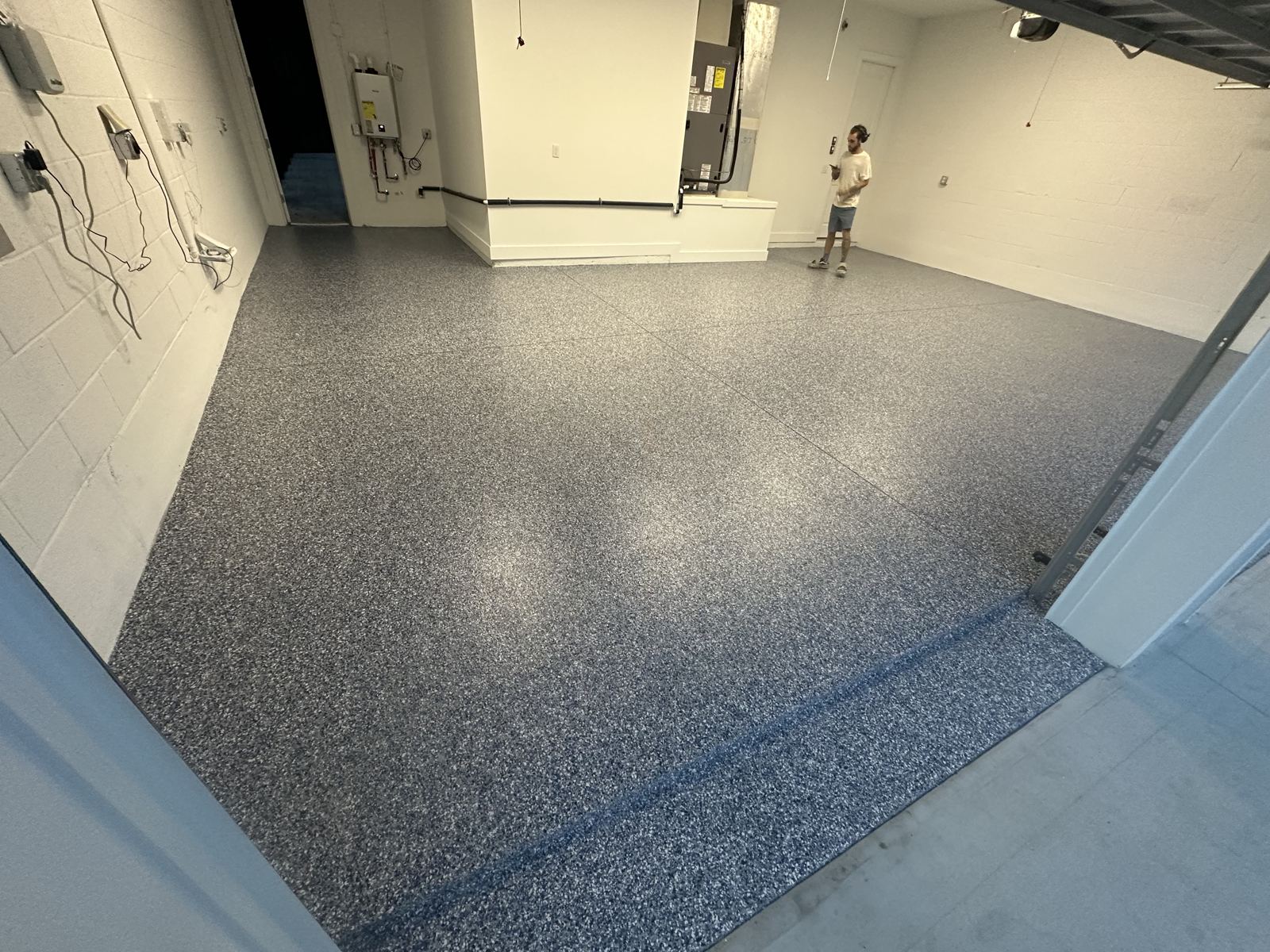 Wide view of a blue flake coated garage floor