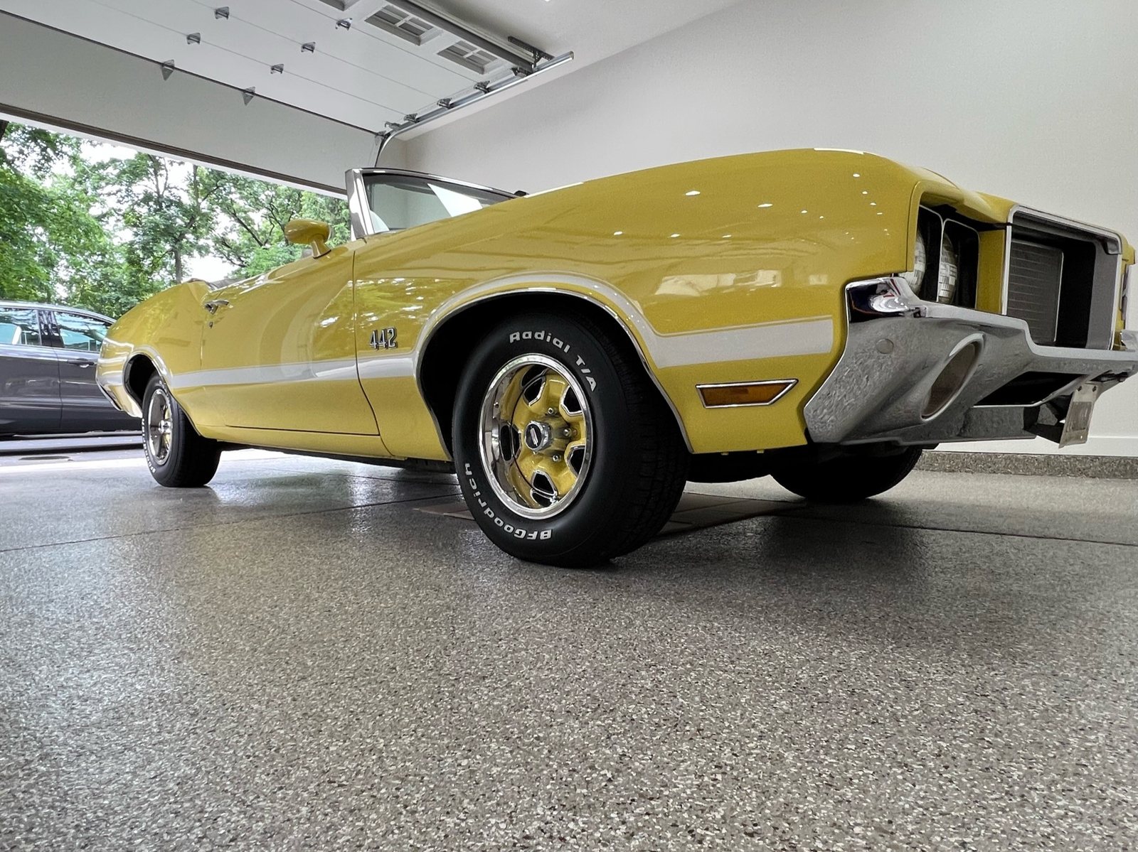 Classic convertible parked on earth tone flake garage floor