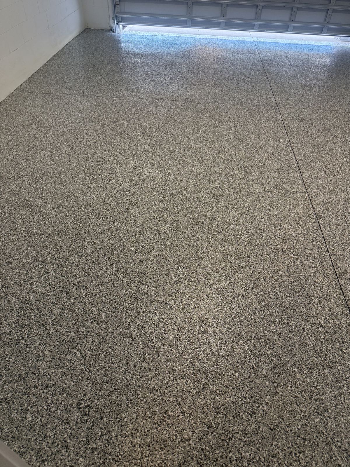Close detail of gray flake broadcast under a clear topcoat