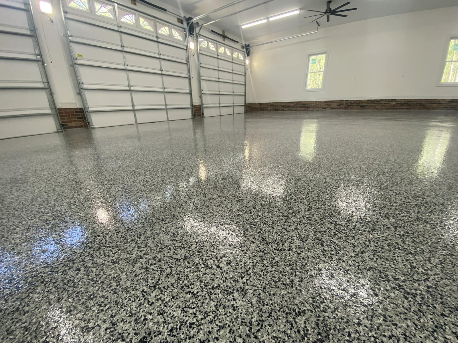 High gloss black and white flake three car garage floor