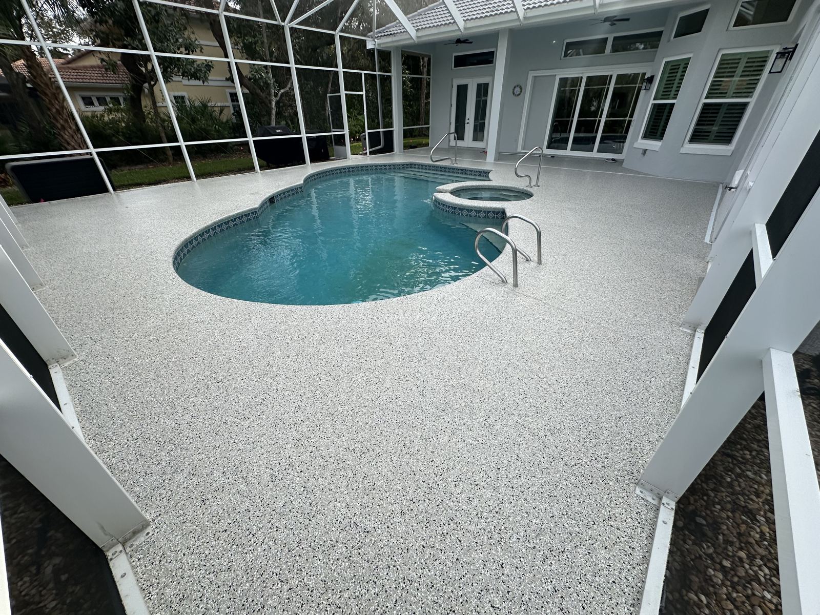 White flake pool deck coating in screened enclosure